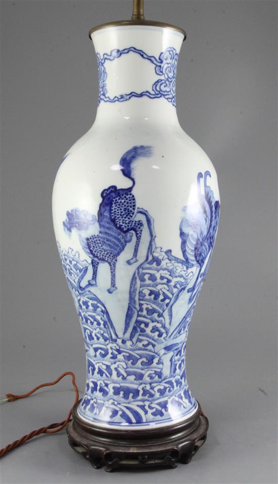 A Chinese blue and white mythical beasts baluster vase, late 19th century/early 20th century, 45cm excluding wood stand and later lam